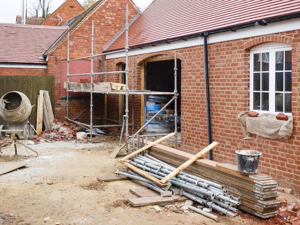 Builder reviewing plans on site