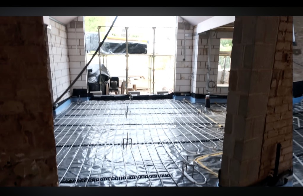 Underfloor heating pipes clipped to a floor before screed